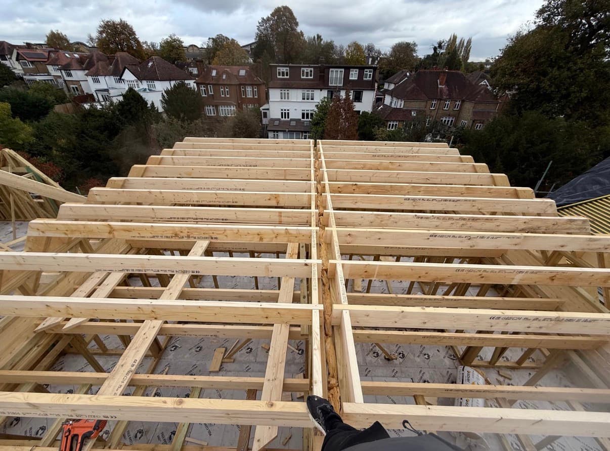Loft conversion floor joists and rafters framed up over a terrace